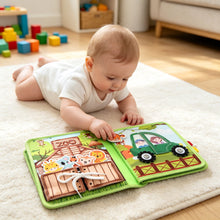Load image into Gallery viewer, Ma Première Visite au Zoo - Livre bébé : bébé à plat ventre joue sur le tapis
