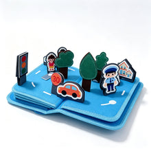Load image into Gallery viewer, Mes Premiers Véhicules - Livre bébé : page 3D détachable avec route, feu tricolore, policier et voiture en feutrine
